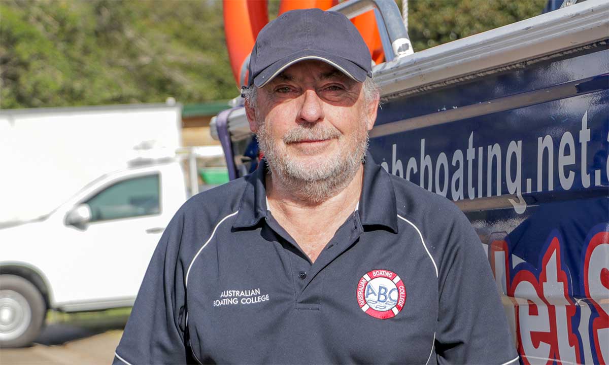 John standing by an Australian Boating College training boat