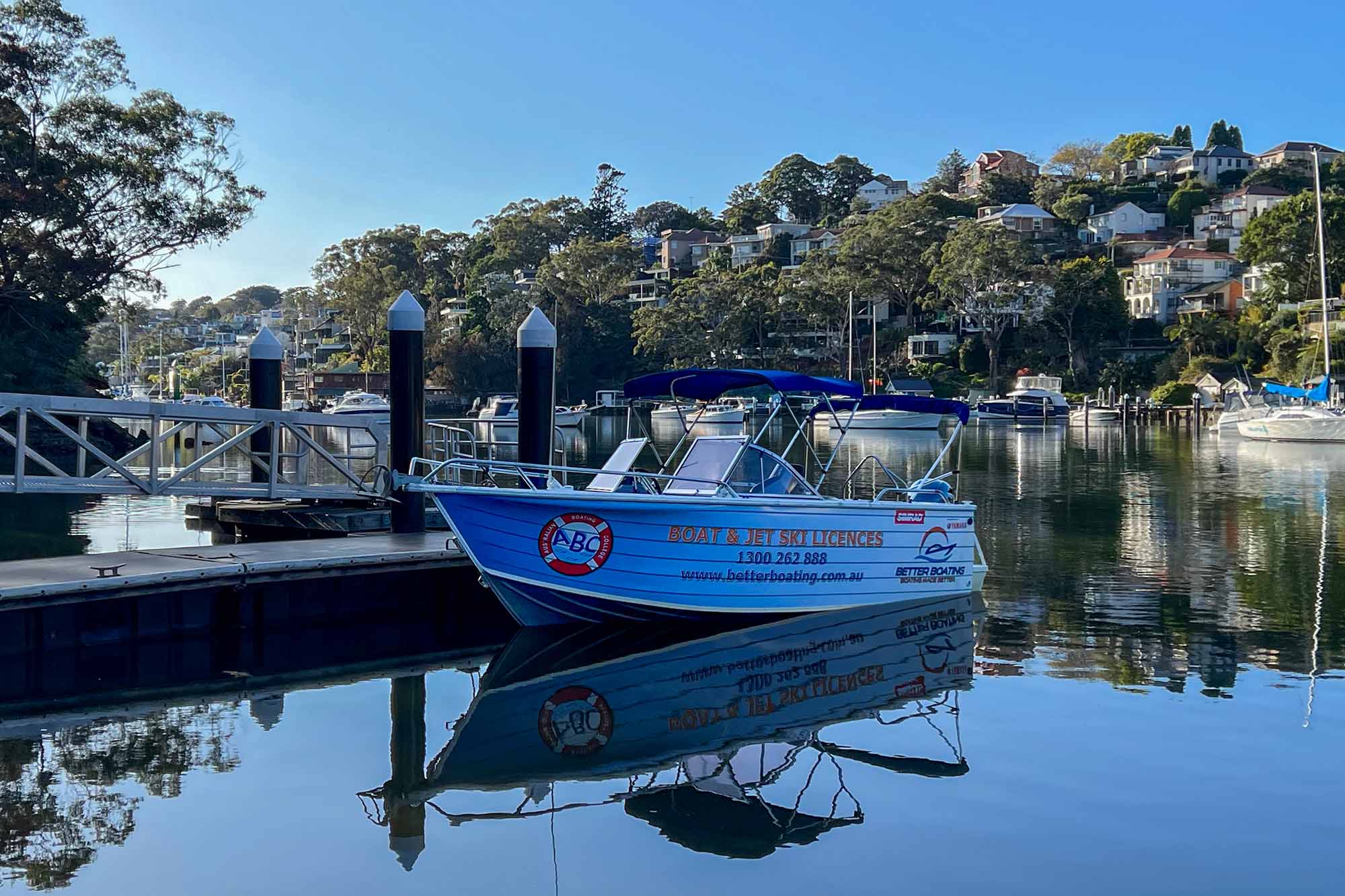 An ABC Boat tied up to the wharf at the Tunks Park Boat Ramp, the practical location of our Cammeray courses